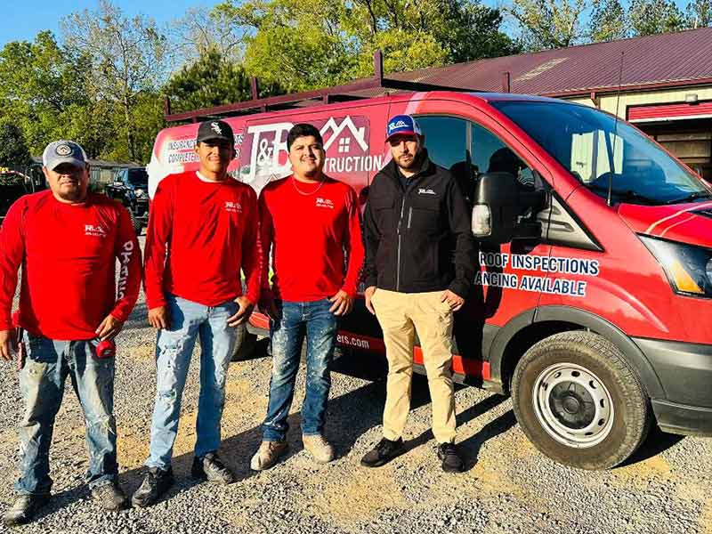 J & B Construction, LLC crew members standing in front of their work van